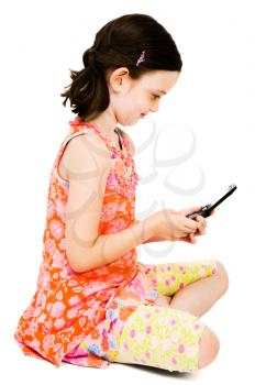 Girl text messaging on a mobile phone and smiling isolated over white