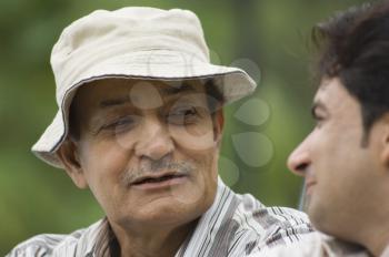 Close-up of a man with his father in a park