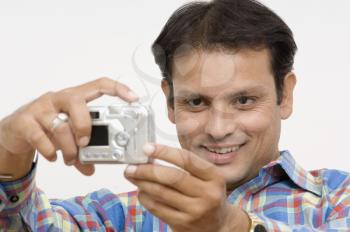 Man taking picture of himself with a digital camera