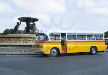 Bus in front of a fountain, Triton Fountain, Valetta, Malta