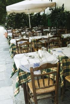 Tables and chairs at a sidewalk cafe, Athens, Greece