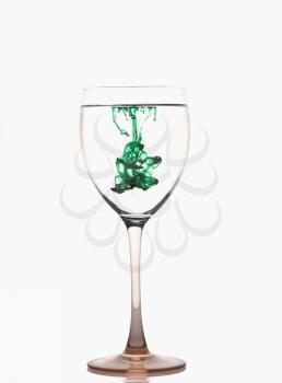 Green color streaks with water in a wine glass