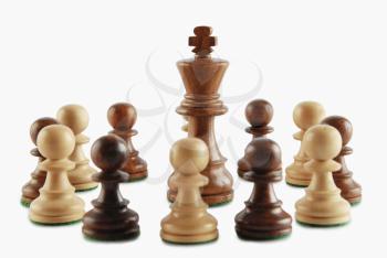 King surrounded by chess pawns