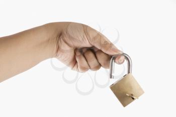 Close-up of a woman's hand holding a padlock