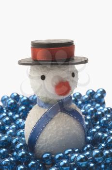 Close-up of a snowman on string of blue beads