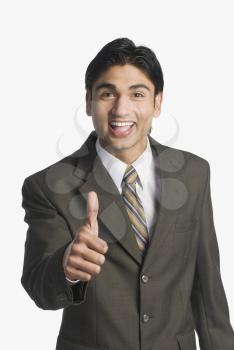 Businessman showing thumbs-up sign
