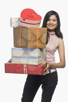 Woman holding gift boxes and smiling