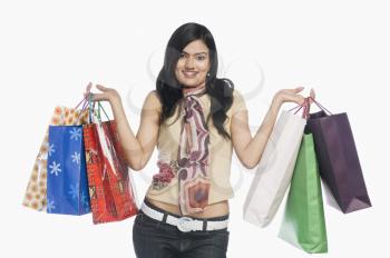 Woman carrying shopping bags and smiling