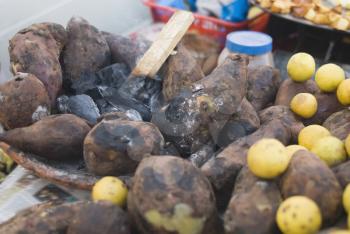 Close-up of sweet potatoes with lemons at a chaat stall, New Delhi, India