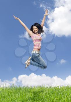 Young woman jumping in a field