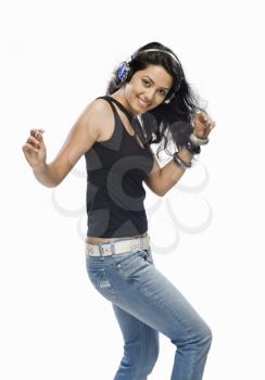 Young woman listening to music and dancing