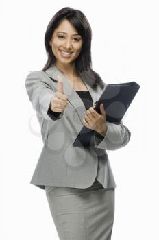 Portrait of a businesswoman holding a file and showing thumbs up
