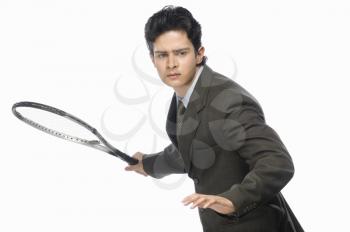 Businessman playing tennis