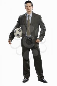 Portrait of a businessman holding a soccer ball