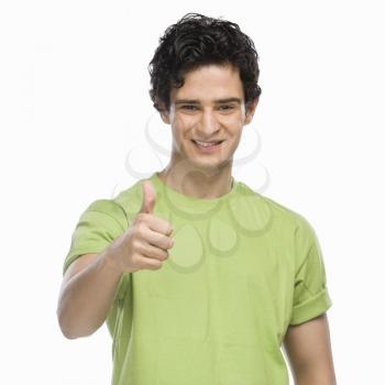 Portrait of a man showing thumbs up sign