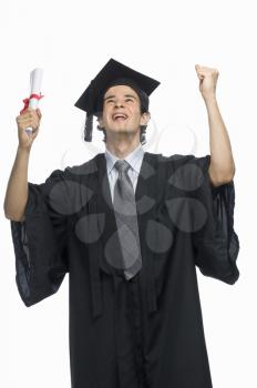 Happy male graduate holding his diploma
