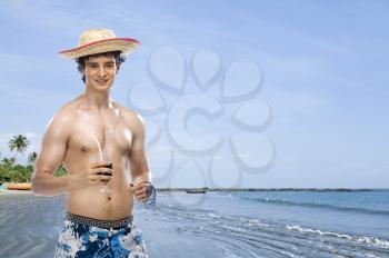 Man drinking soft drink on the beach