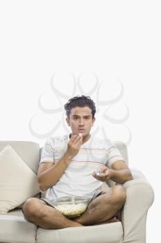 Man watching television and looking surprised