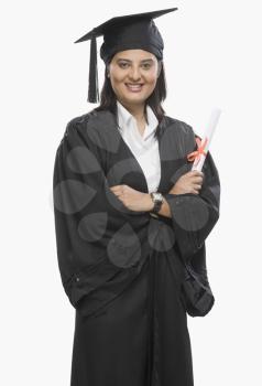 Woman holding a diploma in graduation gown