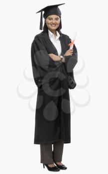 Woman holding a diploma in graduation gown