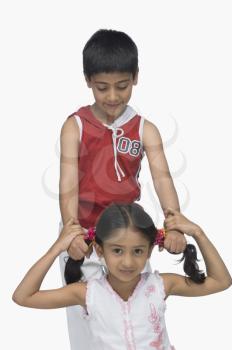 Boy pulling hair of his sister
