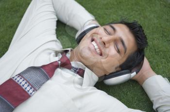 Businessman listening to music and smiling