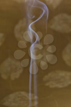 Incense smoke against colored background