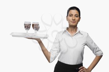 Air hostess carrying a tray of wine glasses