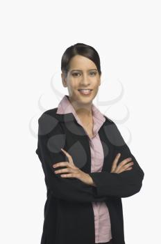 Businesswoman standing with her arms crossed and smiling