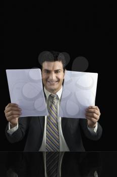 Businessman holding two documents