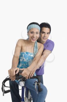 Portrait of a couple sitting on a bicycle