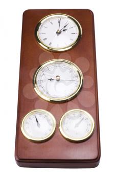 Close-up of a clock with thermometer hygrometer and barometer