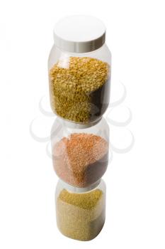 Close-up of stack of assorted pulses in jars