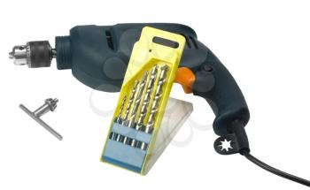 Close-up of an electric drill with drill bits and a key