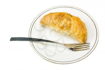 Close-up of a stuffed pastry with a fork in a plate