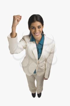 Businesswoman smiling with her hand raised