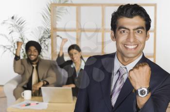 Business executives showing fist and smiling