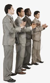 Four businessmen applauding