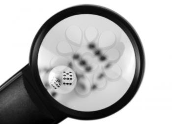 Close-up of a magnifying glass with dices