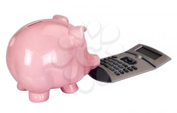 Close-up of a piggy bank with a calculator