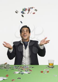 Man tossing gambling chips in a casino