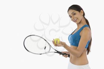 Woman holding a tennis racket and smiling