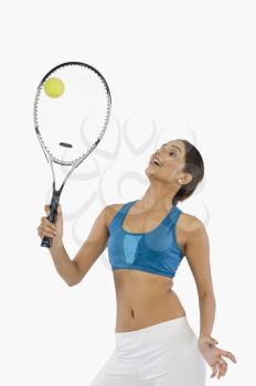 Woman holding a tennis racket with a ball