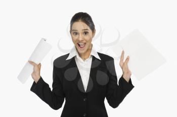 Businesswoman holding documents and smiling