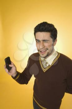 Businessman using a mobile phone and winking
