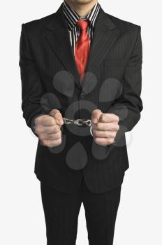 Close-up of a businessman tied up with handcuffs