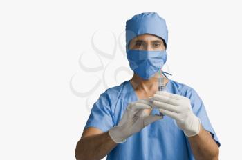 Surgeon holding a syringe