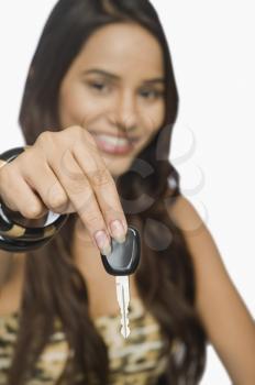 Portrait of a woman showing a car key