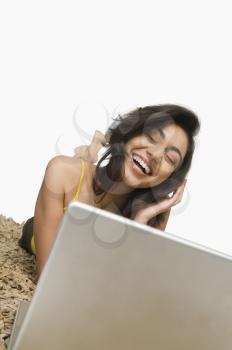 Woman listening to headphones and smiling