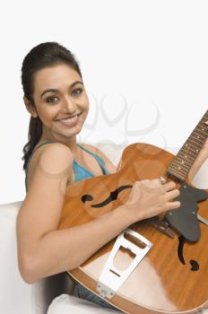 Portrait of a woman playing a guitar